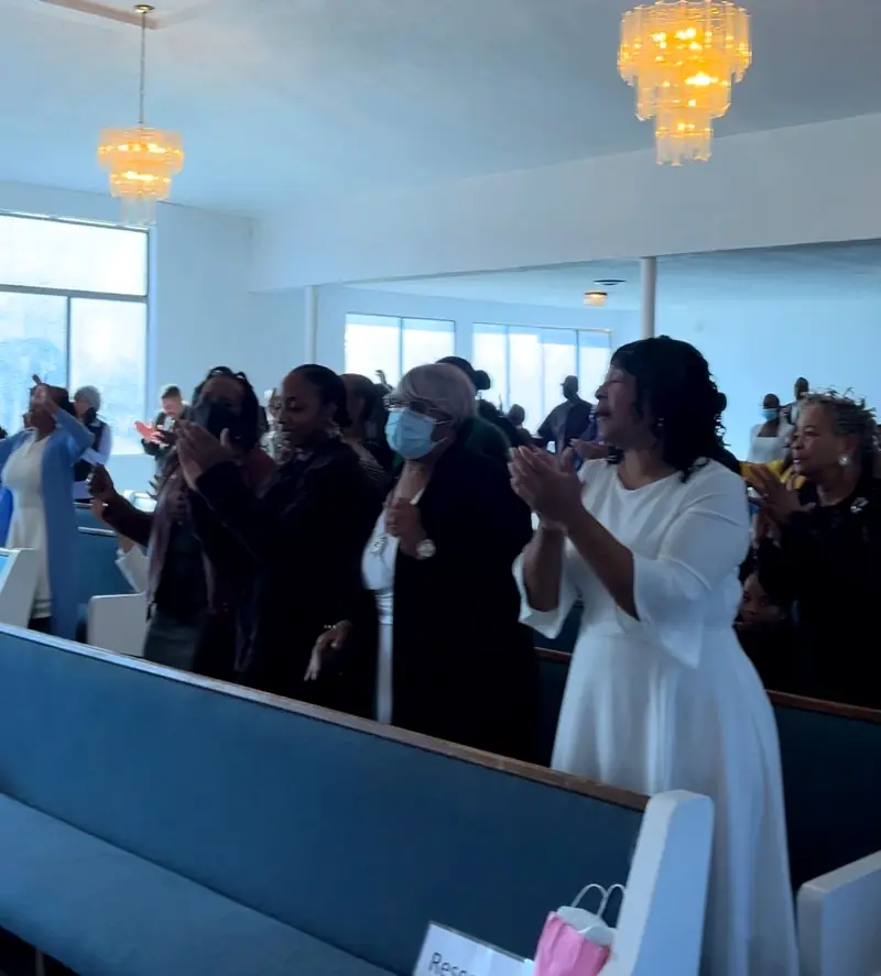 Palm Lane members lifting their hands in praise during Sunday worship