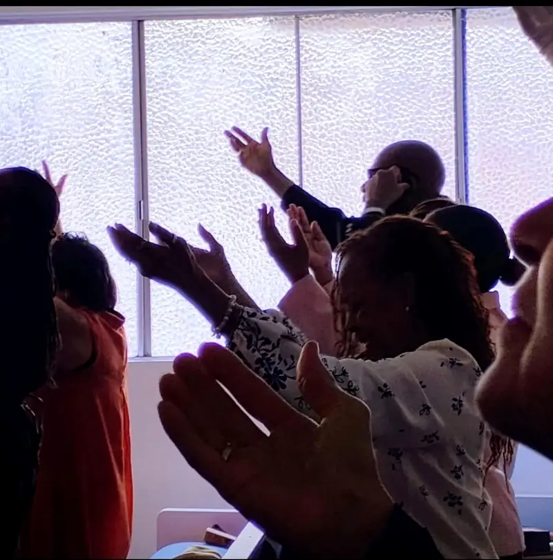 Hands raised in worship at Palm Lane